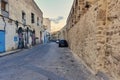 Facades of old buildings in need of renovation next to the ancient city wall of the old town, medina Royalty Free Stock Photo