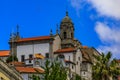 Facades and red tile roofs of traditional houses in old town, a stone church tower in the background in Porto, Portugal Royalty Free Stock Photo