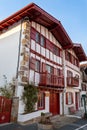 Facades of typical Basque houses in the touristic village of Ainhoa, France Royalty Free Stock Photo