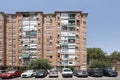 Facades of urban houses with many twin windows and balconies with green awnings