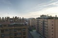 Facades of urban residential houses with many chimneys and the AtlÃÂ©tico de Madrid stadium in the background Royalty Free Stock Photo