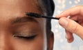 Face of african woman and hand with mascara brush Royalty Free Stock Photo