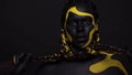Face art. Dancing woman with black and yellow body paint. Young african girl with colorful bodypaint. An amazing afro
