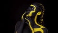 Face art. Dancing woman with black and yellow body paint. Young african girl with colorful bodypaint. An amazing afro