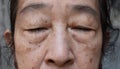 Face of Asian elder woman with closed eyes. Concept of aging