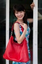 Face of asian woman and red leather fashion bag