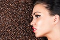 Face of a beautiful woman in coffee beans Royalty Free Stock Photo