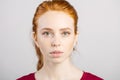 Beautiful young redhead girl with clean fresh face and neutral emotions close up Royalty Free Stock Photo