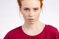 Beautiful young redhead girl with clean fresh face and neutral emotions close up Royalty Free Stock Photo