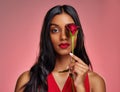 Face, beauty and portrait of a woman with a rose on a studio background for valentines day. Makeup, model and serious