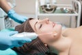 Face Beauty Treatment. Beautician makes Facial Darsonval Therapy for woman Royalty Free Stock Photo