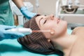 Face Beauty Treatment. Beautician makes Facial Darsonval Therapy for woman Royalty Free Stock Photo