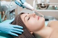 Face Beauty Treatment. Beautician makes Facial Darsonval Therapy for woman Royalty Free Stock Photo
