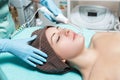 Face Beauty Treatment. Beautician makes Facial Darsonval Therapy for woman Royalty Free Stock Photo