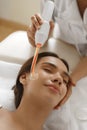 Face Beauty Treatment. Woman Using Darsonval Skin Care Device Royalty Free Stock Photo