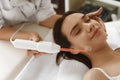 Face Beauty Treatment. Woman Using Darsonval Skin Care Device Royalty Free Stock Photo