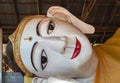 Face of big white reclining Buddha red lip statue in myanmar temple Royalty Free Stock Photo