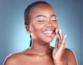 Face of black woman for skincare, beauty and eyes closed on blue background for wellness, facial and spa. Salon Royalty Free Stock Photo