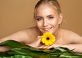 Face and Body Beauty Spa. Smiling Model with Smooth Skin and Wet Hair. Women Facial Care Cosmetics. Woman relax with Flower Royalty Free Stock Photo