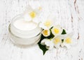 Face and body cream moisturizers with jasmine flowers on white w Royalty Free Stock Photo