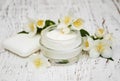 Face and body cream moisturizers with jasmine flowers on white w Royalty Free Stock Photo