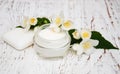Face and body cream moisturizers with jasmine flowers on white w Royalty Free Stock Photo