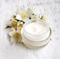 Face and body cream moisturizers with jasmine flowers Royalty Free Stock Photo