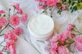 Face and body cream with pink roses on white Royalty Free Stock Photo