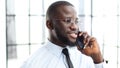 The face of a businessman man in close-up he is talking on the phone in the office Royalty Free Stock Photo