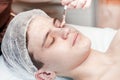 Face Care, acne skin problem, Cosmetology face care for a teenager boy years old, toned Royalty Free Stock Photo