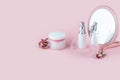 Face care cosmetics. Jars of cream and face serum on a pink background. Beauty Salon Concept