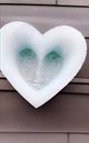 Face caught up in iced cold heart, created with Generative AI technology