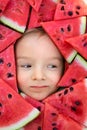 A boy framed by triangular pieces of watermelon.Cute portrait of a baby Royalty Free Stock Photo