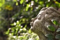 Face of a child sculpture on side is made of cement in the garden with shining light. Royalty Free Stock Photo