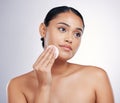 Face, cleaning and cotton on skin of a woman in studio for natural beauty, dermatology or cosmetics. Female person with