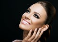 Face close-up of a beautiful young woman isolated on dark background; perfect skin, beauty portrait Royalty Free Stock Photo