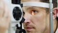 face close-up , man doing eye test with non contact tonometer, cheking vision, intraocular pressure at optical clinic