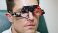 Face close-up , ophthalmologist examining patient man with optometrist trial frame, visual inspection device. male