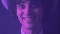 Face closeup view of an isolated young brunette man with attractive toothy smile