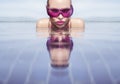 Face closeup of woman in purple sunglasses in infinity rooftop swimming pool