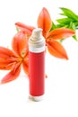 Face cream/lotion with lily flowers,on white Royalty Free Stock Photo