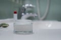 Face cream, face roller and lipstick near the sink on the counter in the bathroom Royalty Free Stock Photo