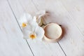 Face cream with white orchid on wooden table. Royalty Free Stock Photo
