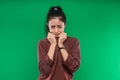 The face of a crying expression of a young Asian woman while holding his chin with both hands Royalty Free Stock Photo