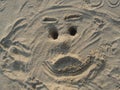 Face drawn in sand