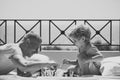 Face fashion little boy or kid in your web site. Smart toddler concept. Parent play chess with kid on terrace on sunny