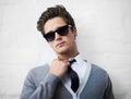 Face, fashion and sunglasses with cool man in studio on white background for attitude or style. Portrait, shades and tie Royalty Free Stock Photo