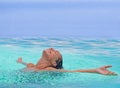 Face, freedom and rain with woman in swimming pool for travel, holiday or vacation as tourist. Relax, smile and wet in