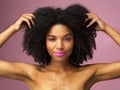 Face, hair care and black woman with afro in studio isolated on a pink background with eyeshadow. Hairstyle portrait