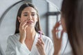 Face Hair Depilation. Confused Lady With Razor In Hand Looking At Mirror